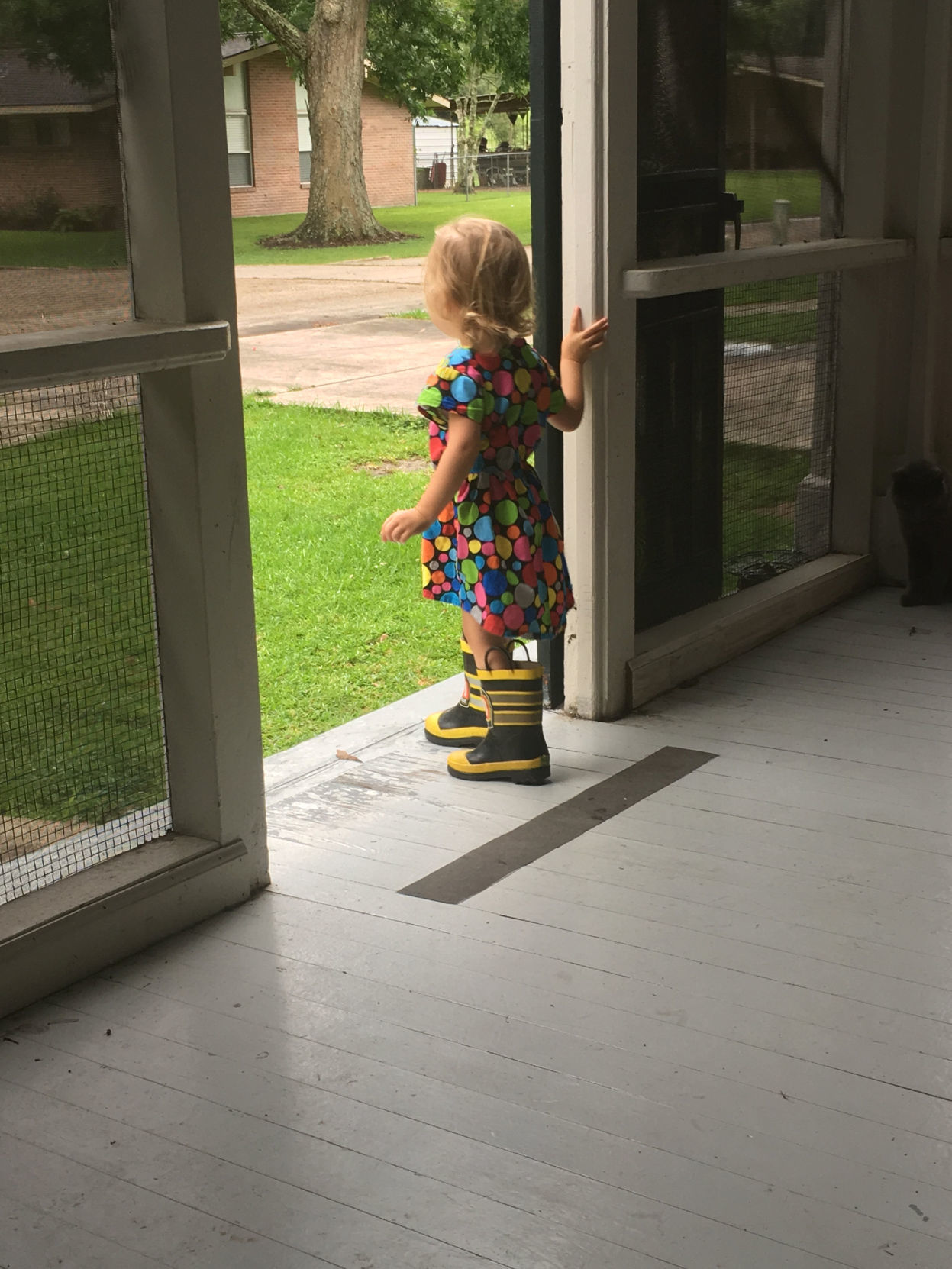 Emily Price looks out the front door of her family's duplex on Gillis W. Long National Guard Center in Carville